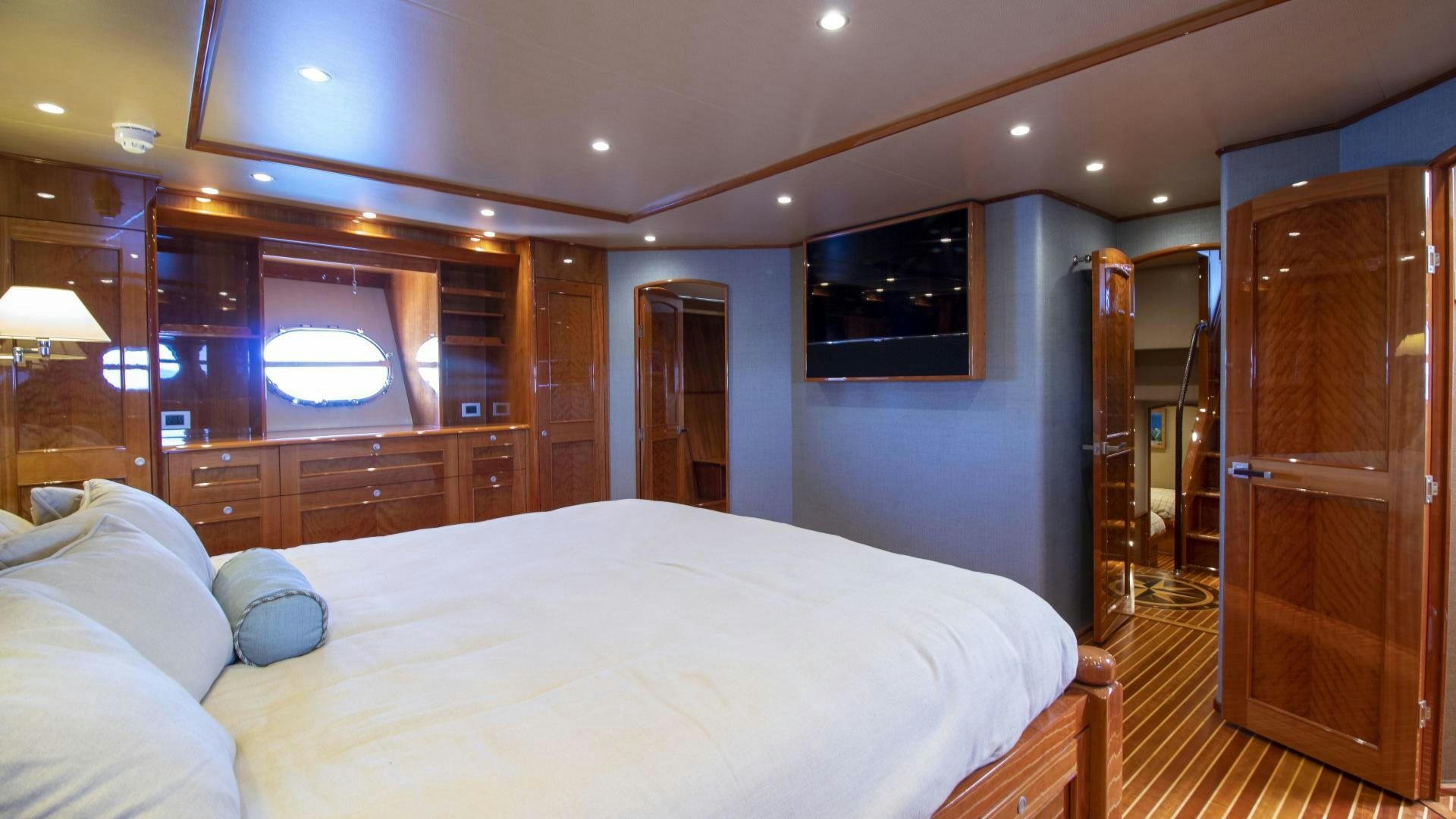 a bedroom with a bed and a television aboard VICTORY Yacht for Sale
