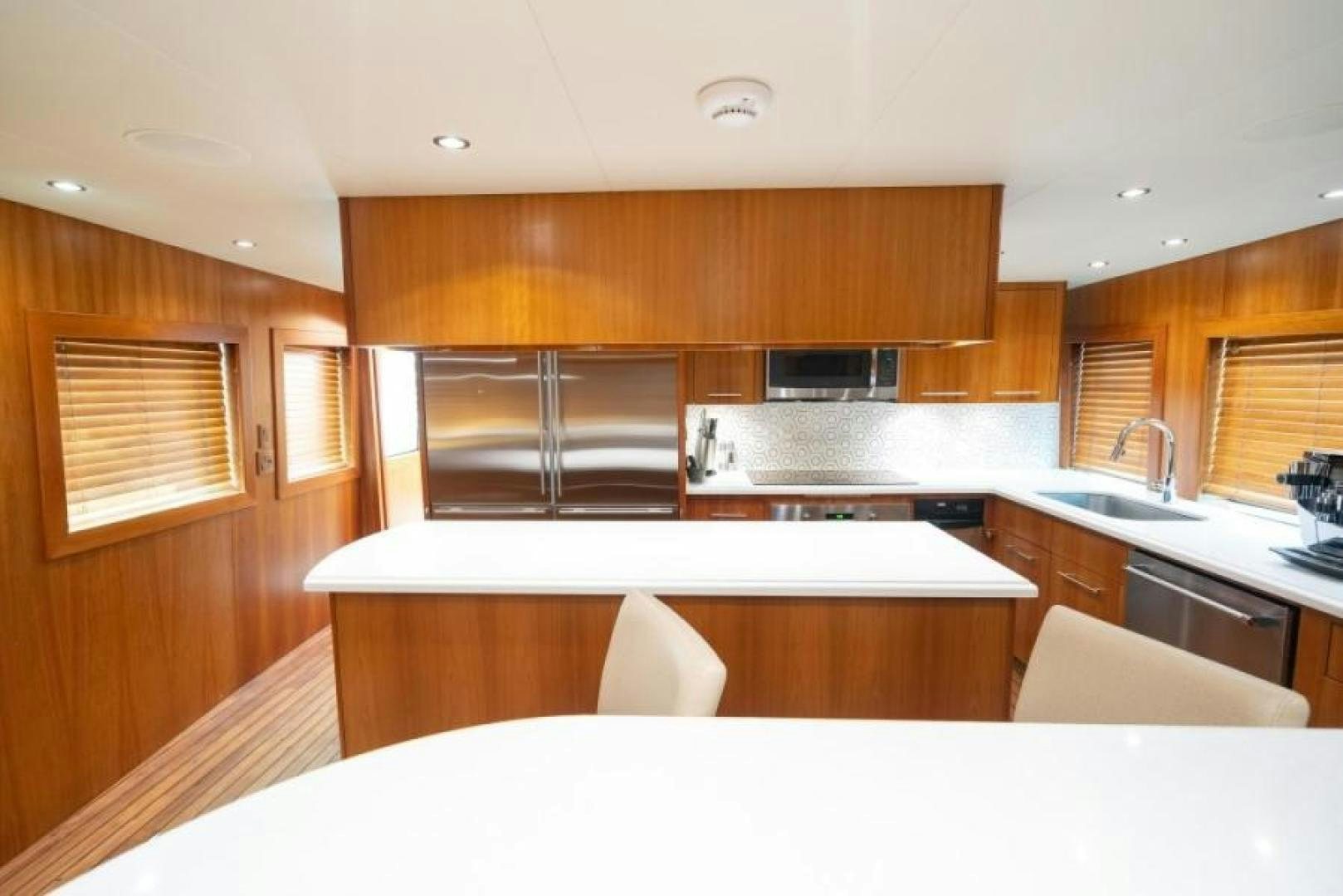 a kitchen with wooden cabinets aboard DANIELLE Yacht for Sale