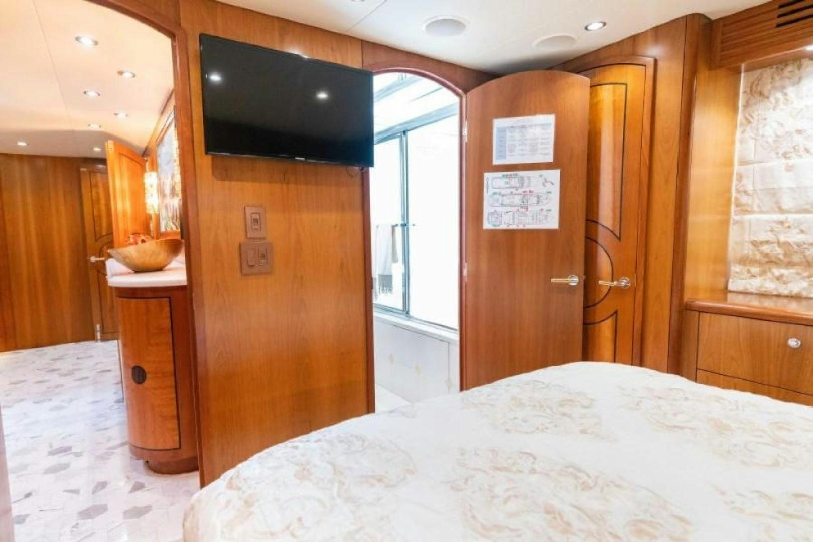 a bedroom with a tv and a bed aboard DANIELLE Yacht for Sale