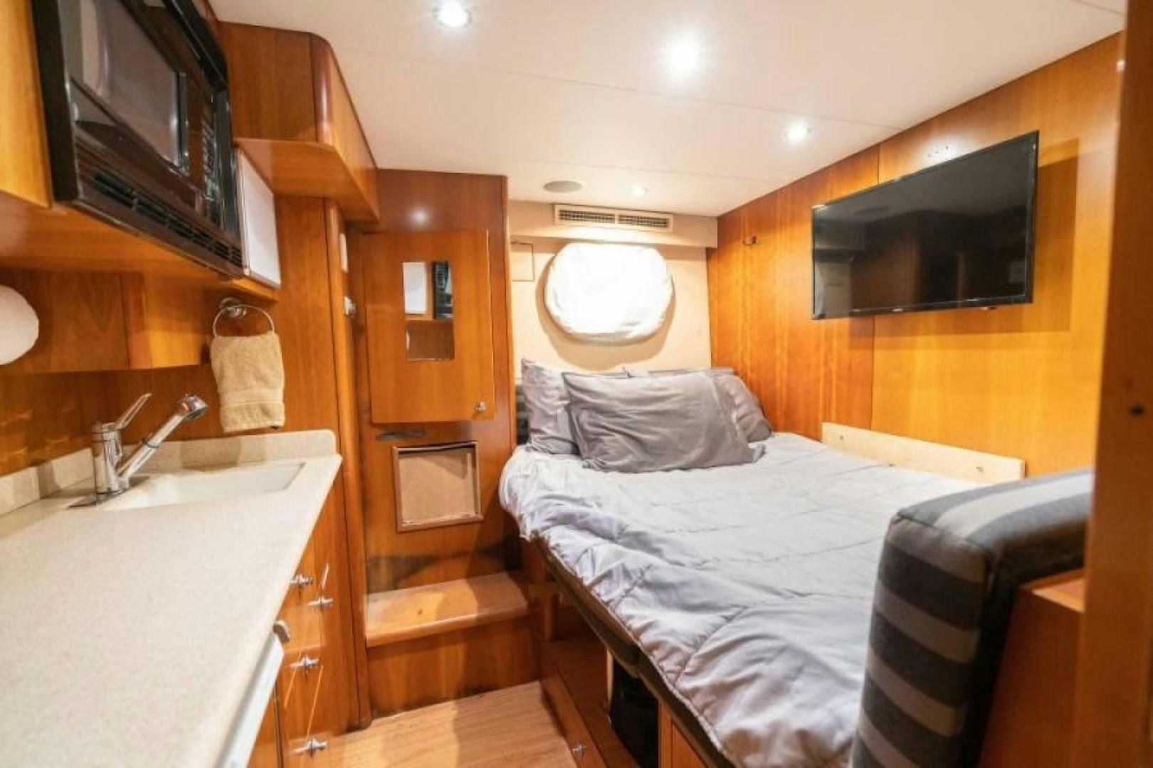 a bedroom with a bed and a sink aboard DANIELLE Yacht for Sale
