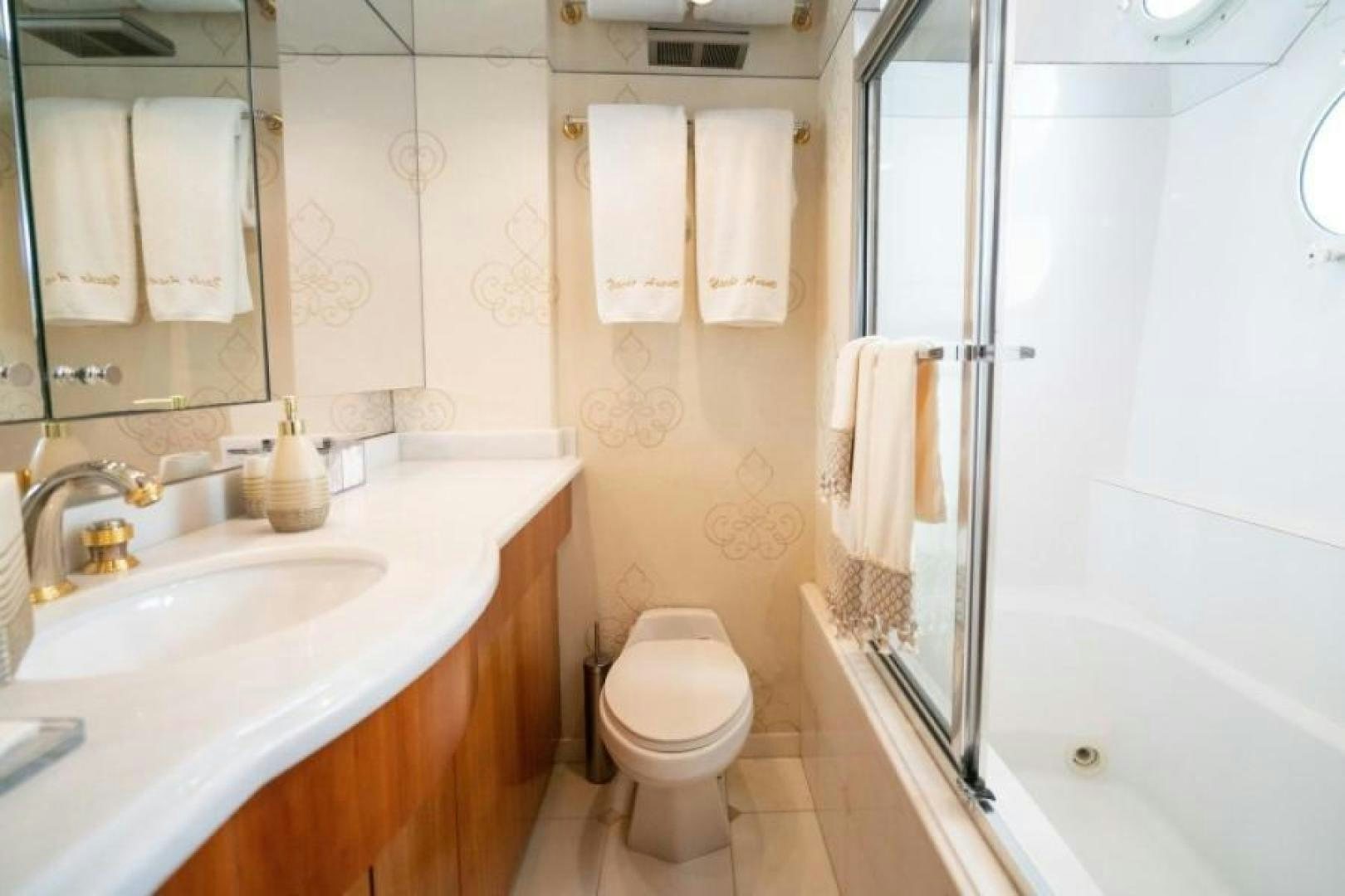 a bathroom with a sink toilet and bathtub aboard DANIELLE Yacht for Sale