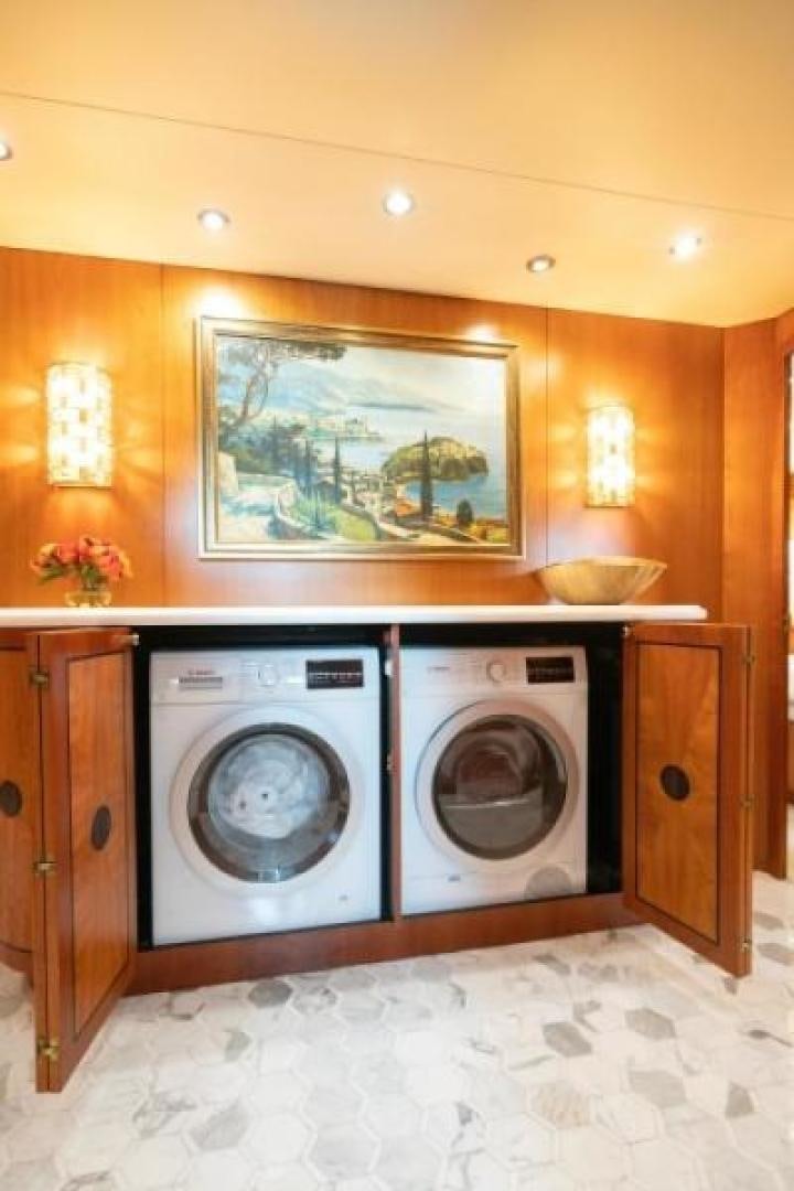 a room with a washing machine and dryer aboard DANIELLE Yacht for Sale