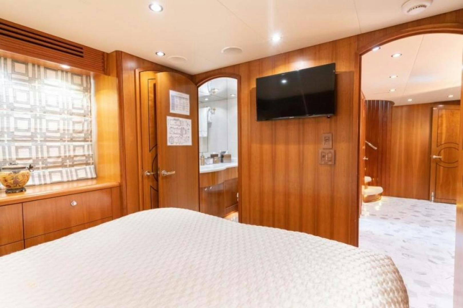 a bedroom with a tv on the wall aboard DANIELLE Yacht for Sale