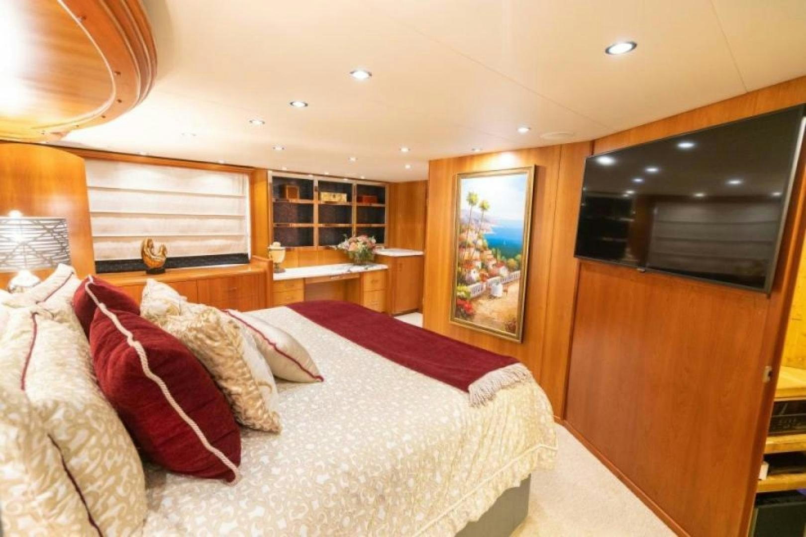 a bedroom with a bed and a desk aboard DANIELLE Yacht for Sale