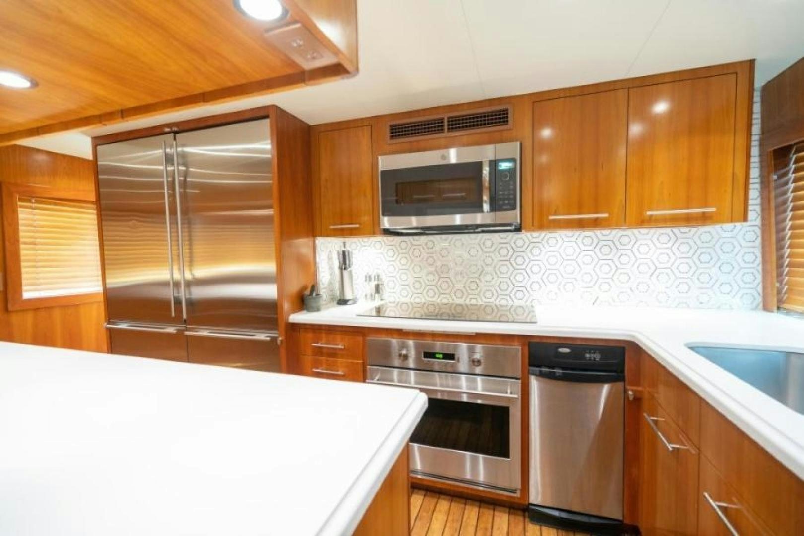 a kitchen with wooden cabinets aboard DANIELLE Yacht for Sale