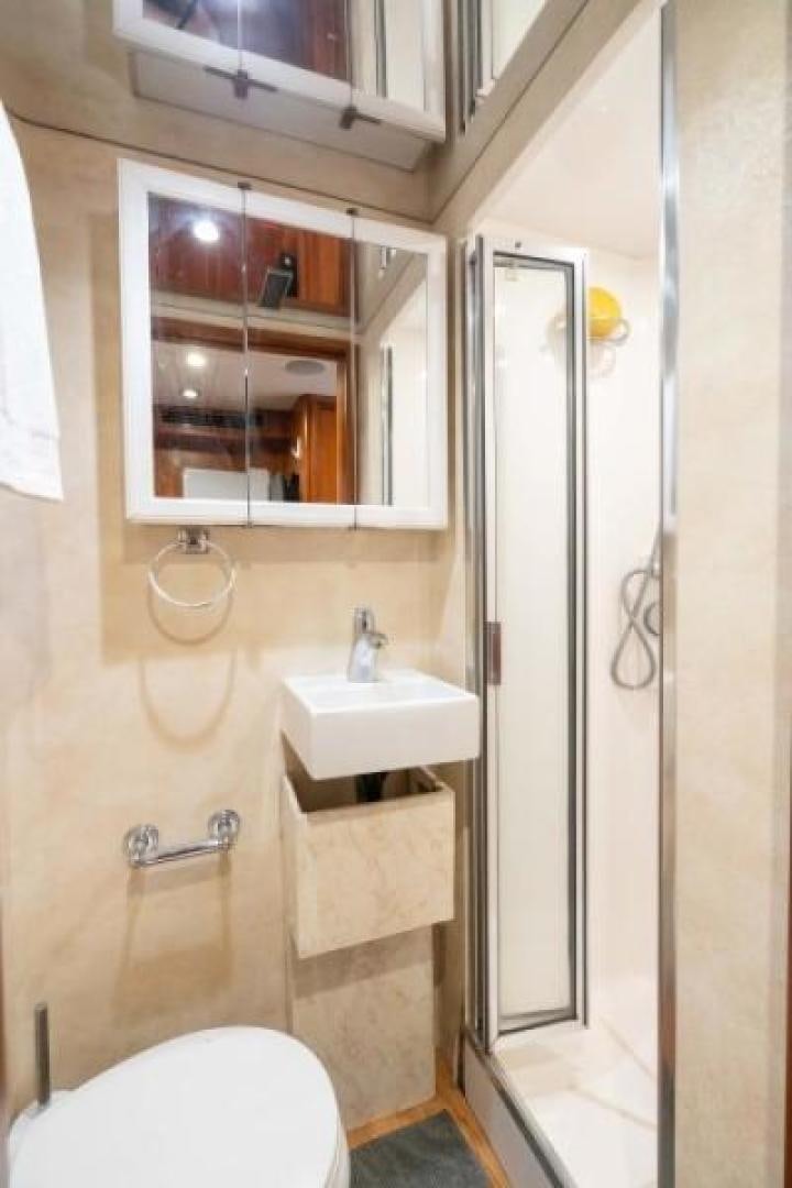 a bathroom with a glass shower door aboard DANIELLE Yacht for Sale