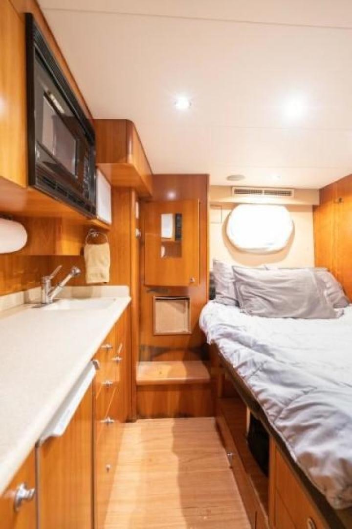 a small bedroom with a small bed aboard DANIELLE Yacht for Sale