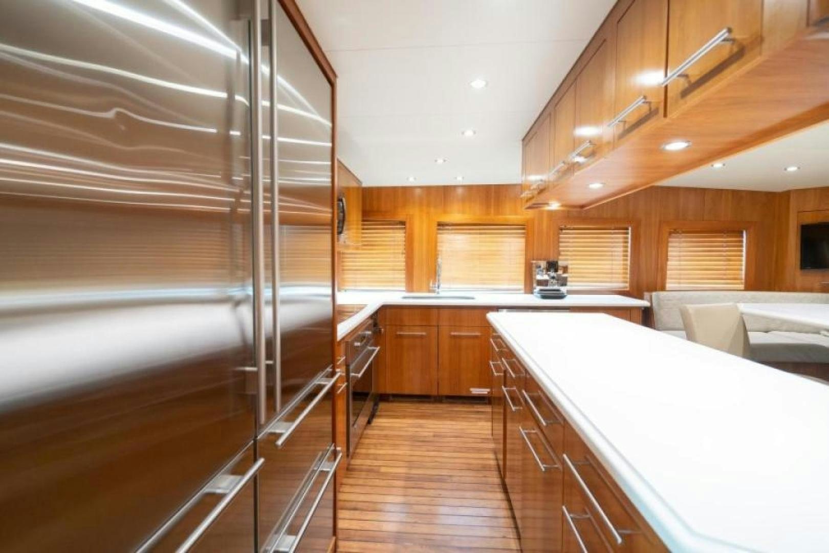a kitchen with wooden cabinets aboard DANIELLE Yacht for Sale