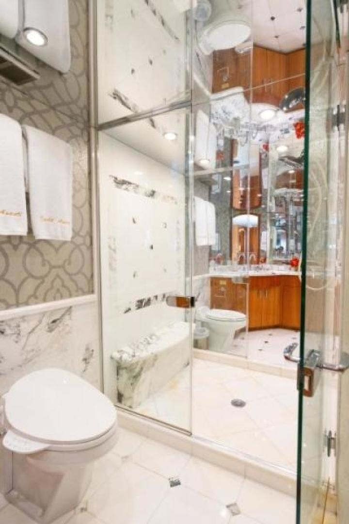 a bathroom with a toilet and a shower aboard DANIELLE Yacht for Sale