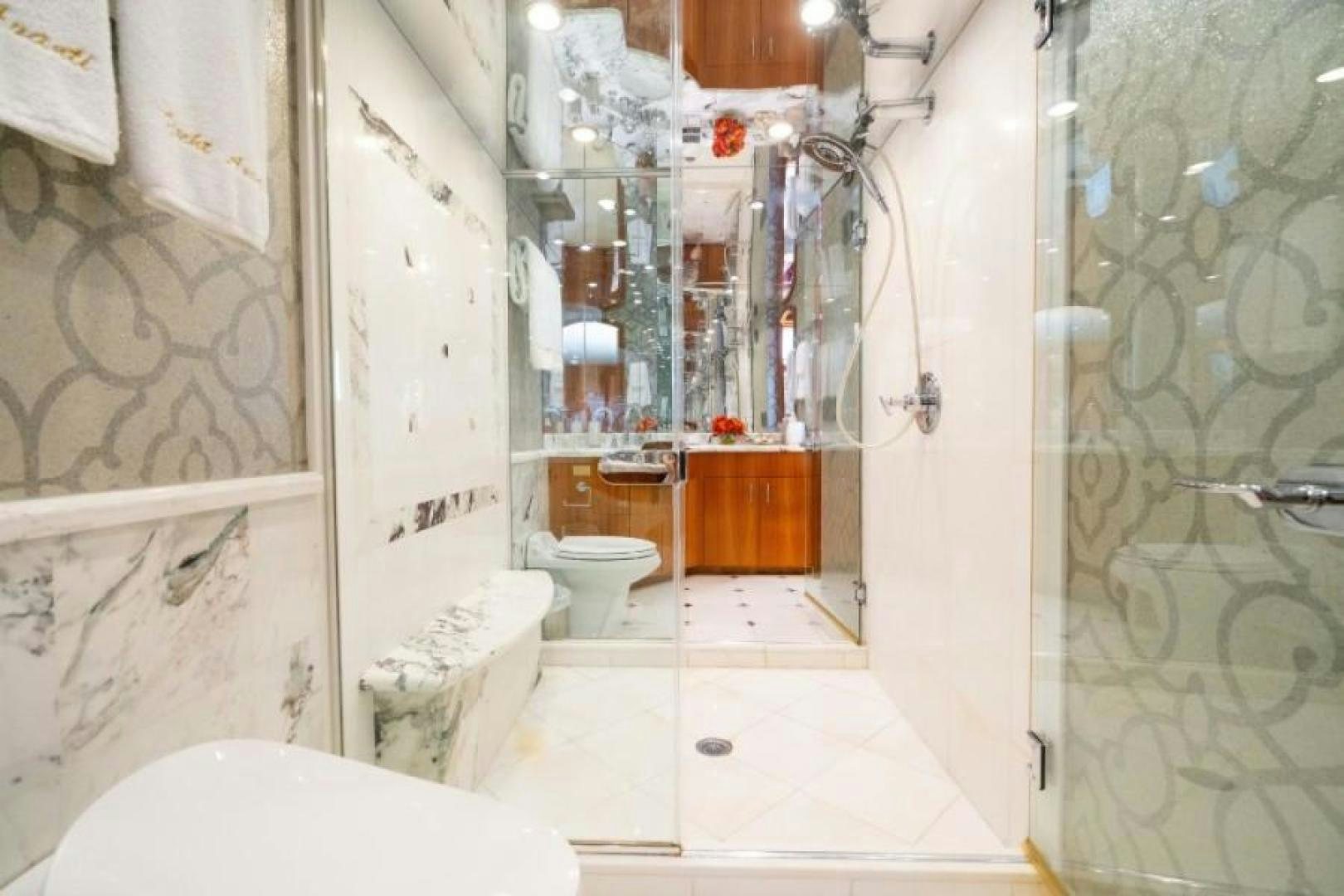 a bathroom with a toilet and shower aboard DANIELLE Yacht for Sale