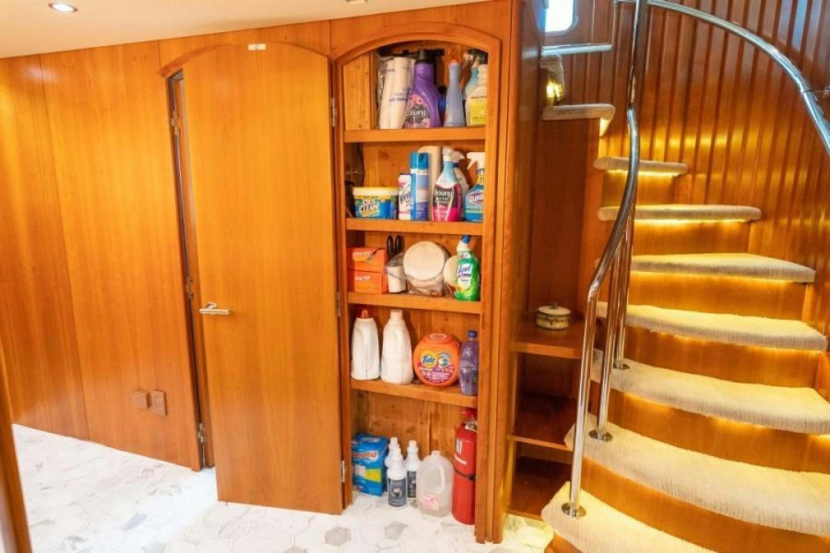 a wooden door with a shelf of bottles and cans on it aboard DANIELLE Yacht for Sale