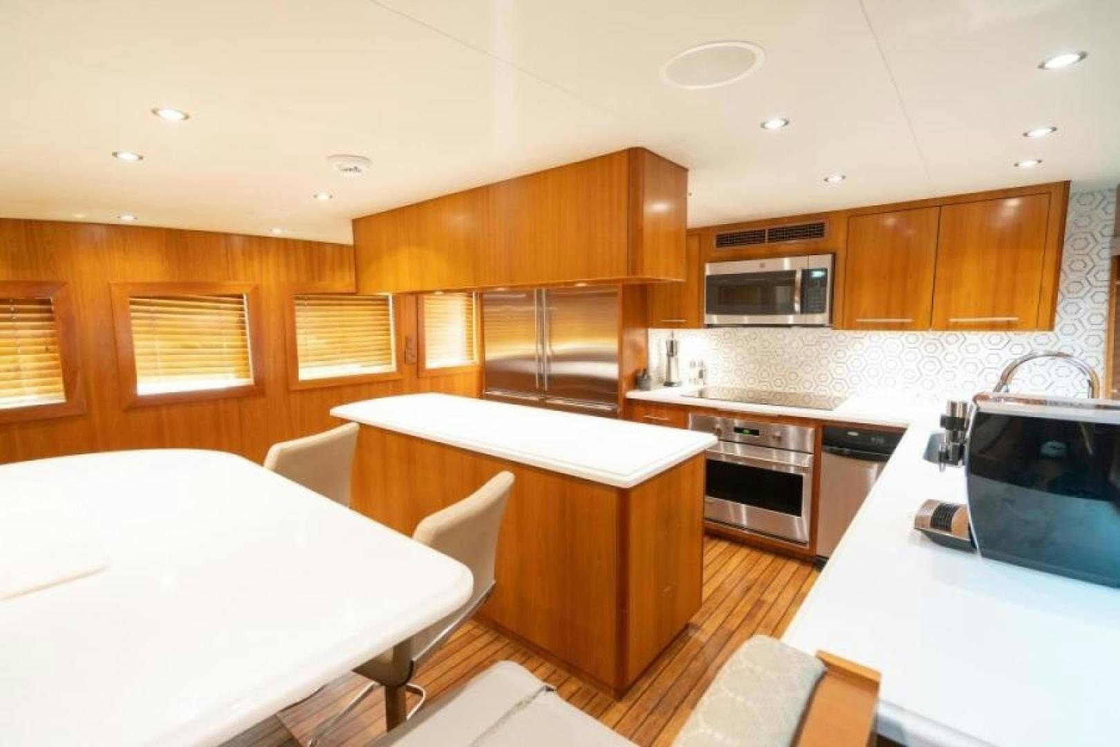 a kitchen with wooden cabinets aboard DANIELLE Yacht for Sale