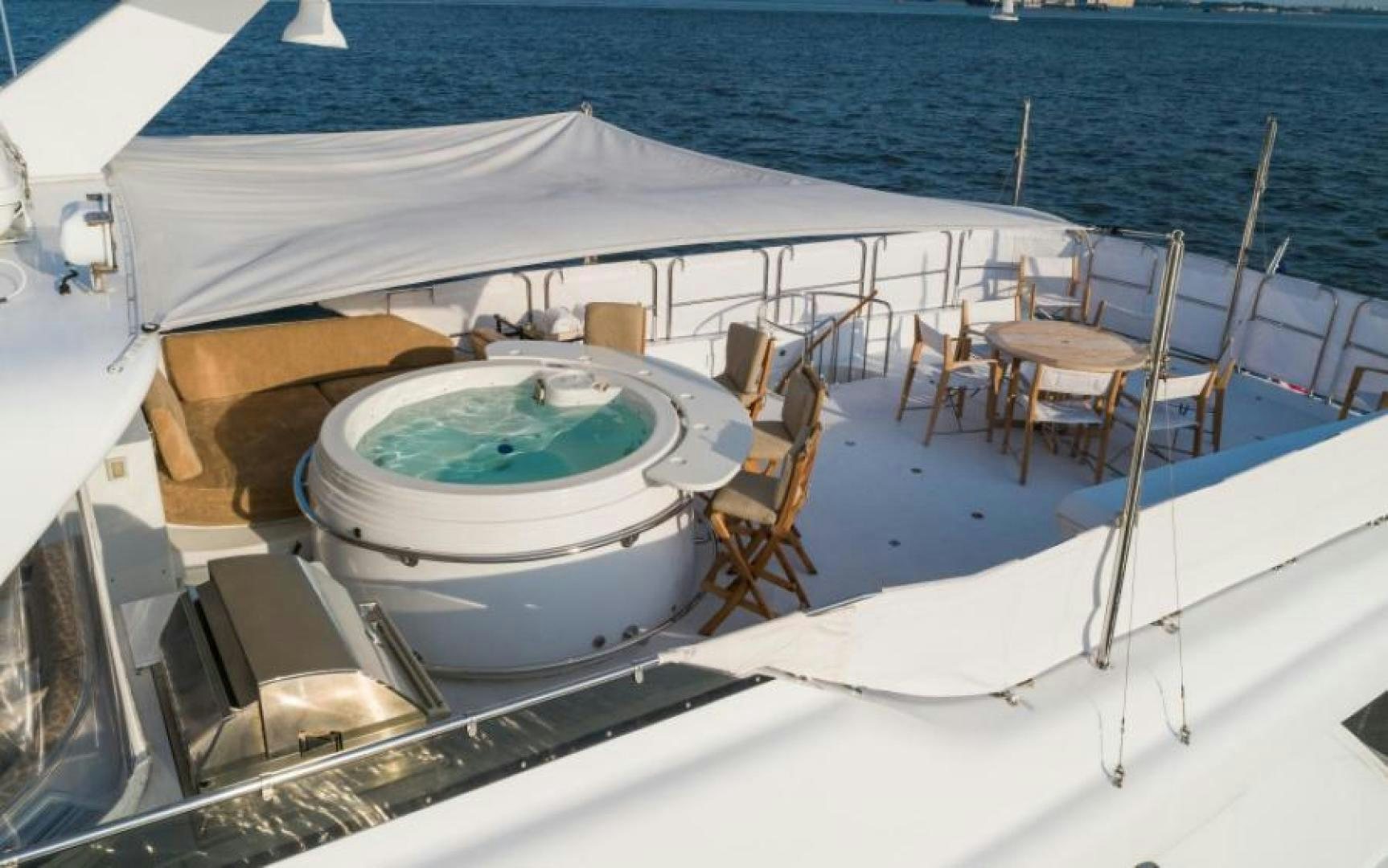 a boat with a table and chairs on the deck aboard DANIELLE Yacht for Sale