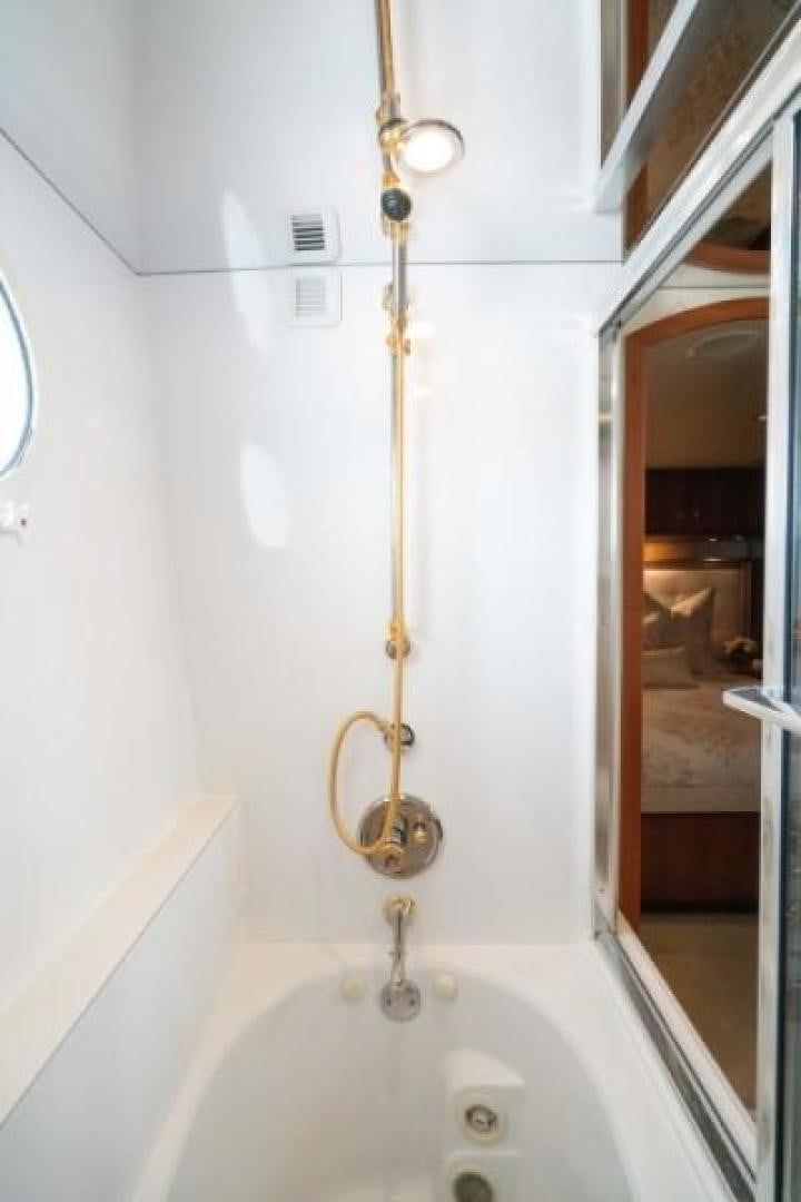 a gold chain on a white bathtub aboard DANIELLE Yacht for Sale