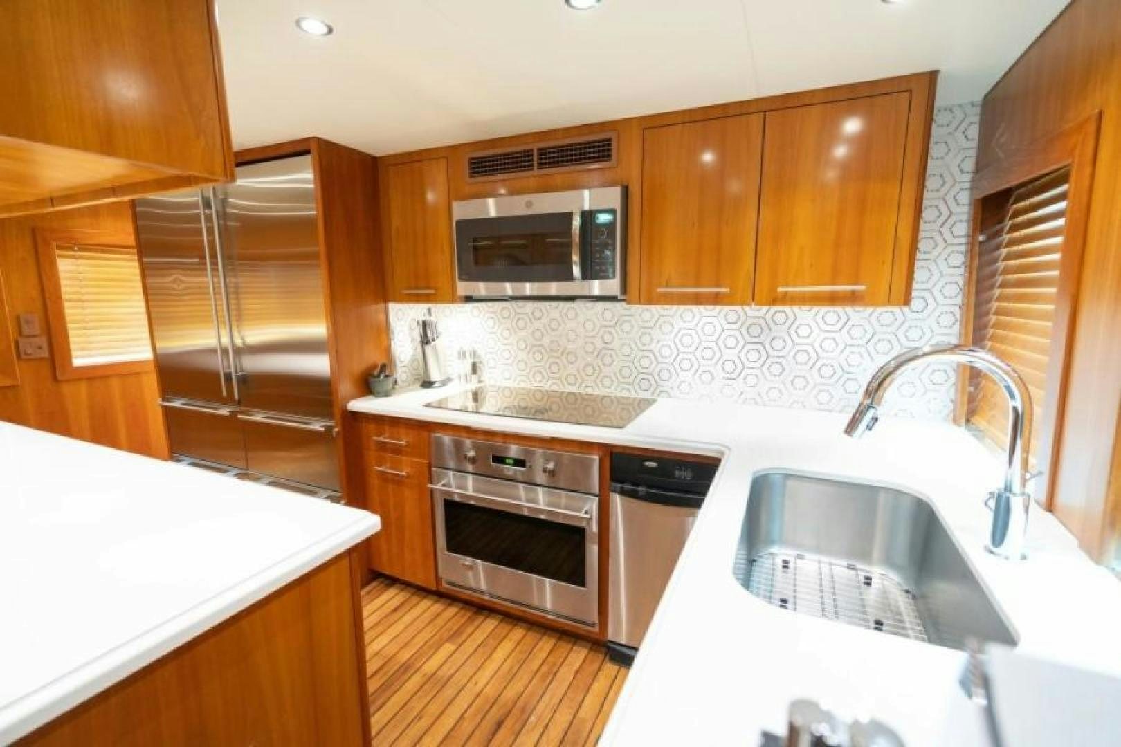 a kitchen with wooden cabinets aboard DANIELLE Yacht for Sale