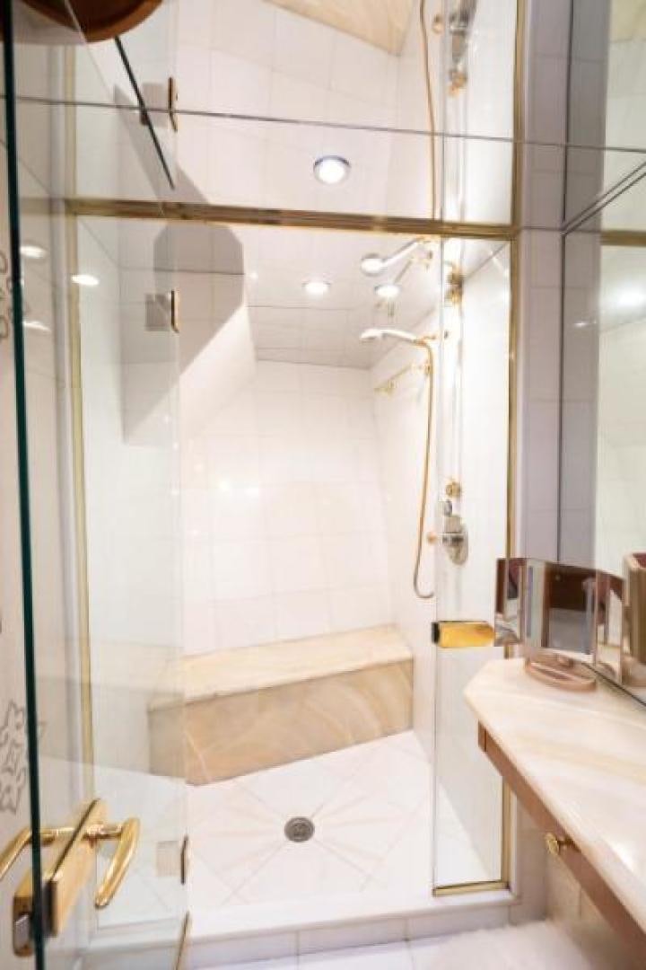 a bathroom with a shower and sink aboard DANIELLE Yacht for Sale