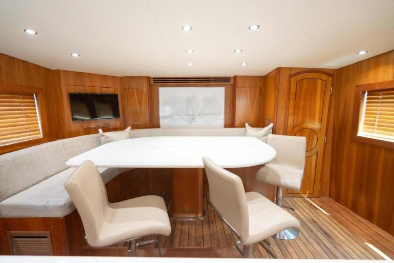a large kitchen with a large white table and chairs aboard DANIELLE Yacht for Sale