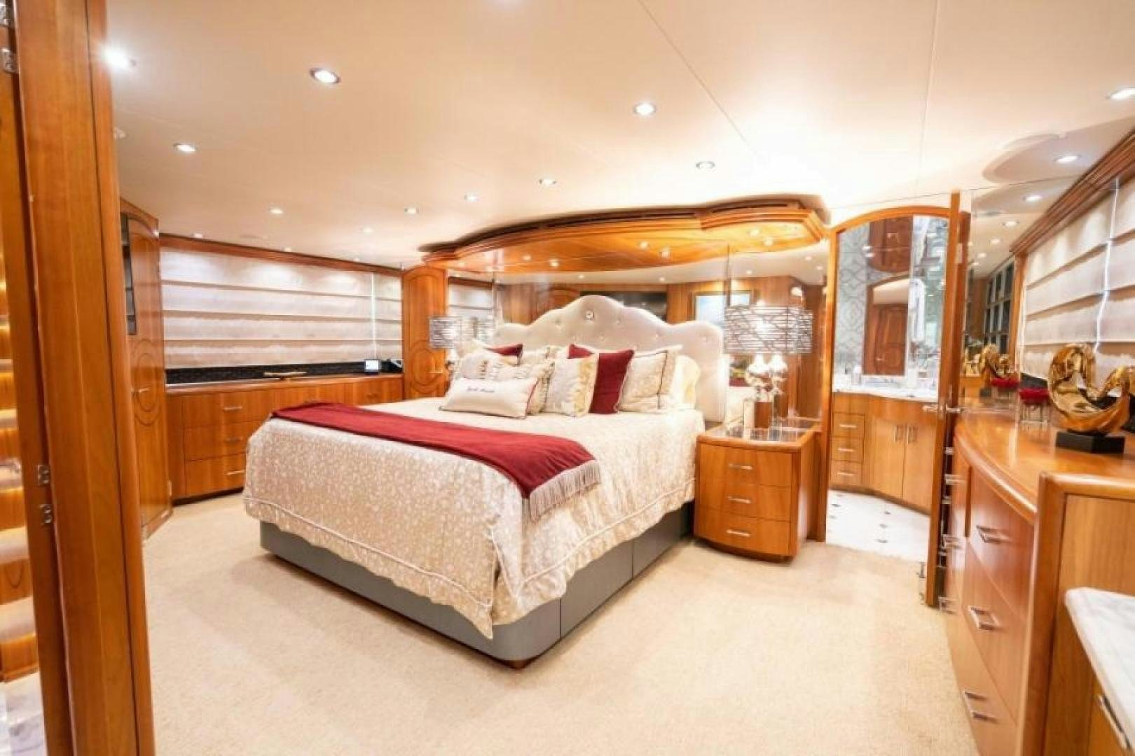 a bedroom with a bed and a dresser aboard DANIELLE Yacht for Sale