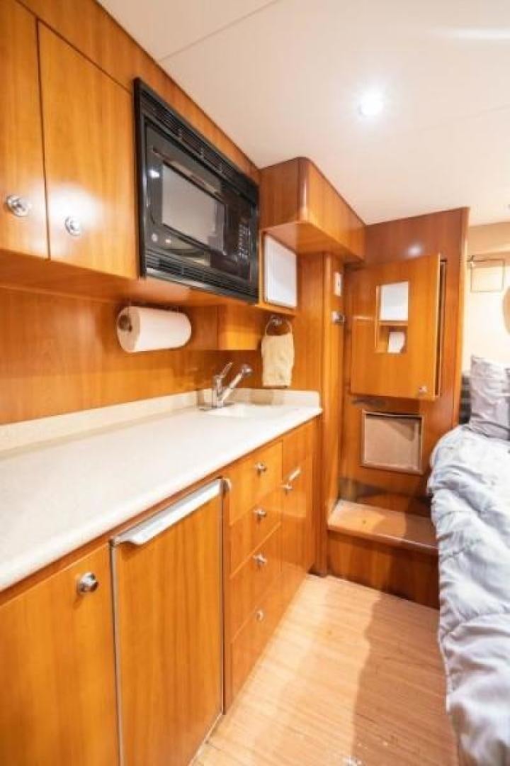 a kitchen with wooden cabinets aboard DANIELLE Yacht for Sale