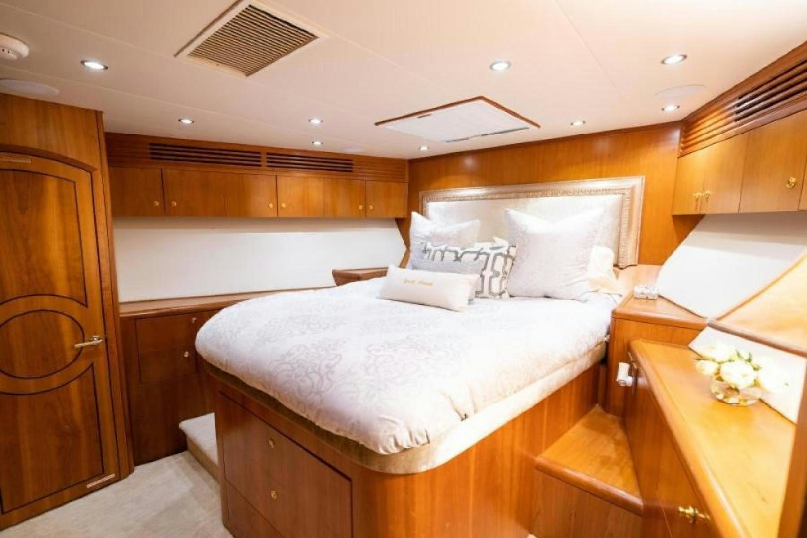 a bedroom with a bed and a table aboard DANIELLE Yacht for Sale