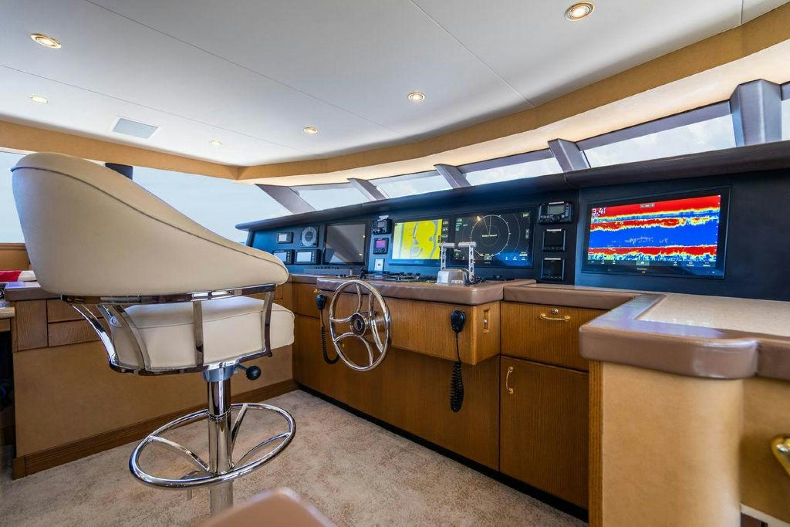 a room with a desk and chairs aboard NORTH COAST 120 Yacht for Sale