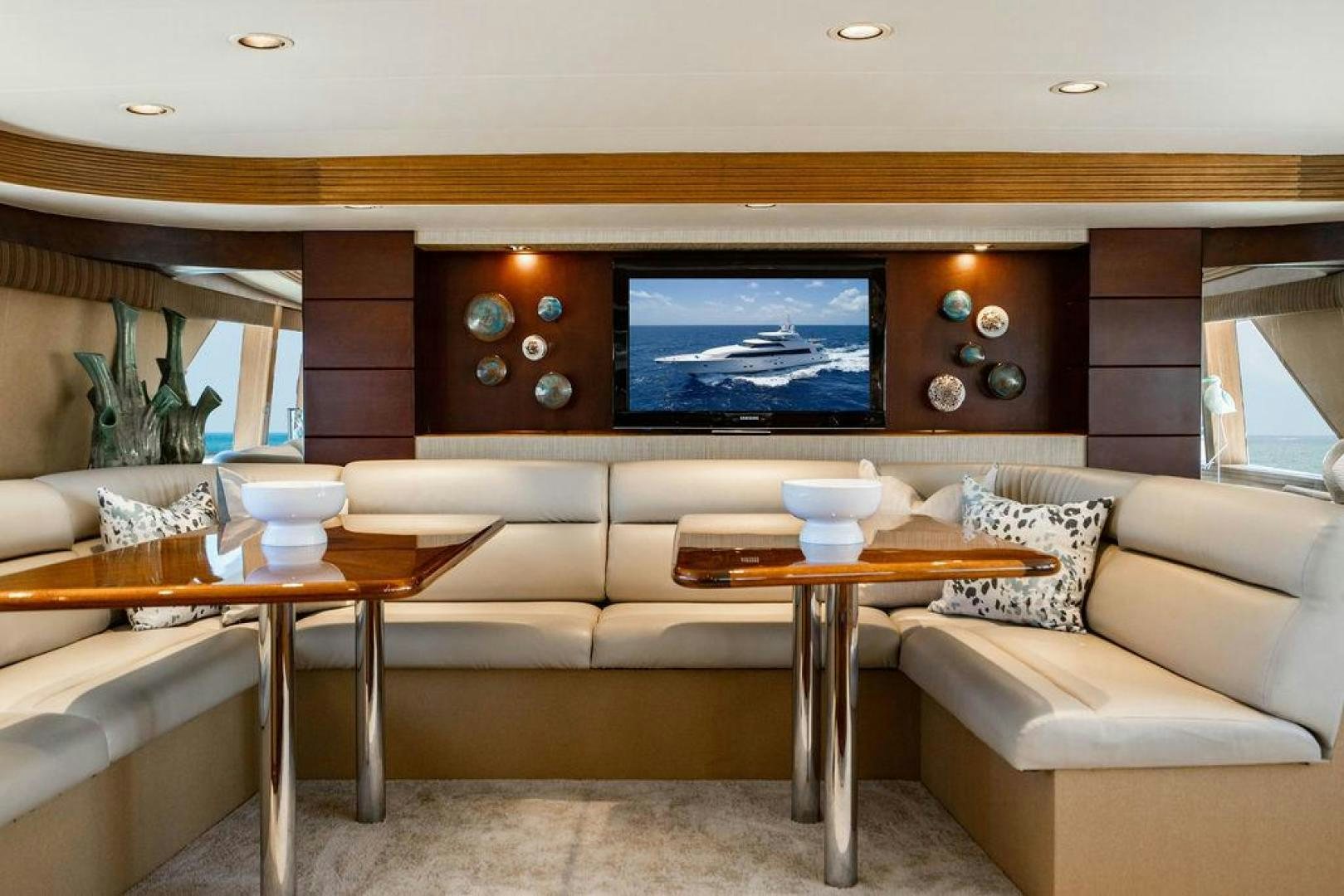 a living room with a tv and furniture aboard NORTH COAST 120 Yacht for Sale
