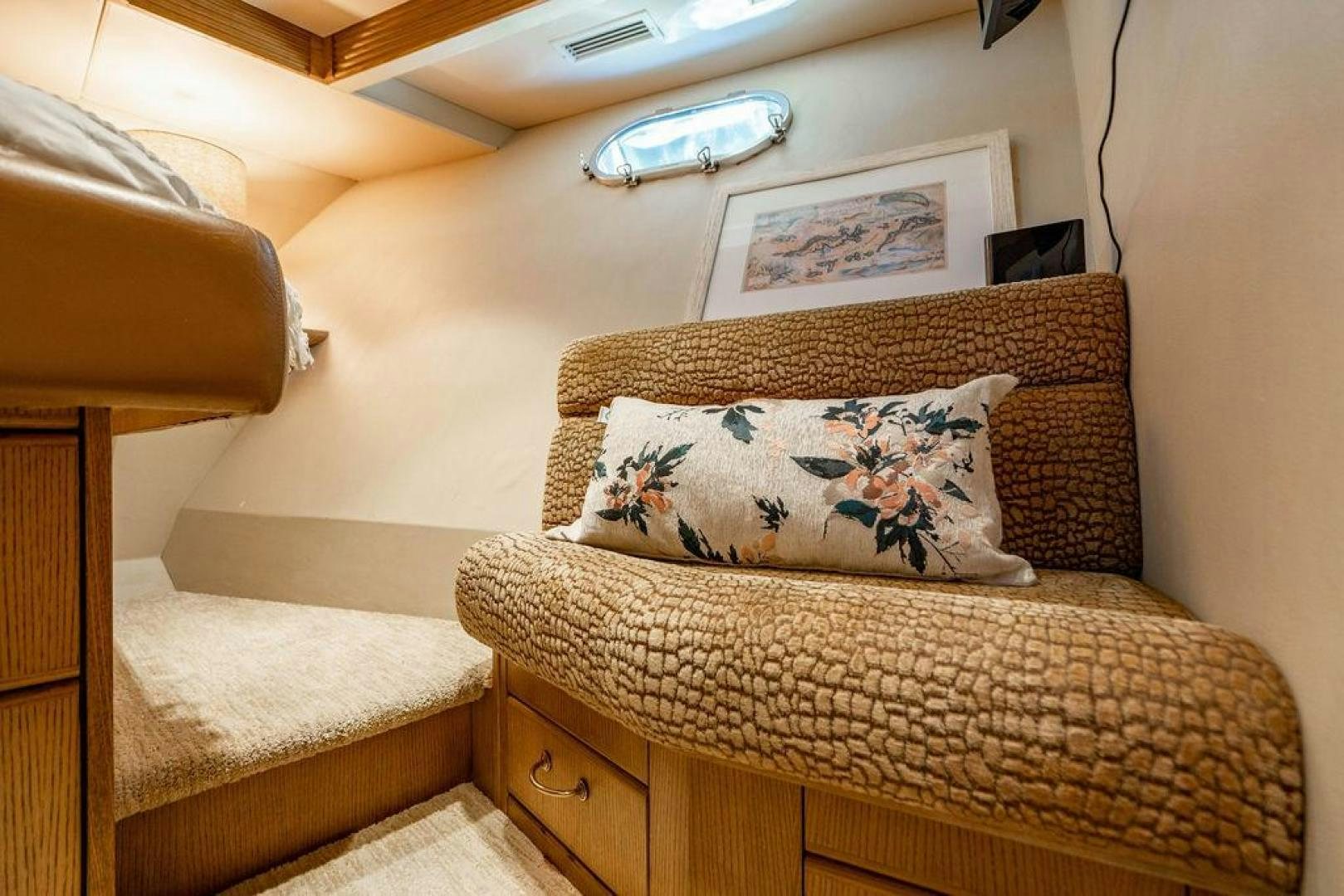 a couch with a pillow on it aboard NORTH COAST 120 Yacht for Sale