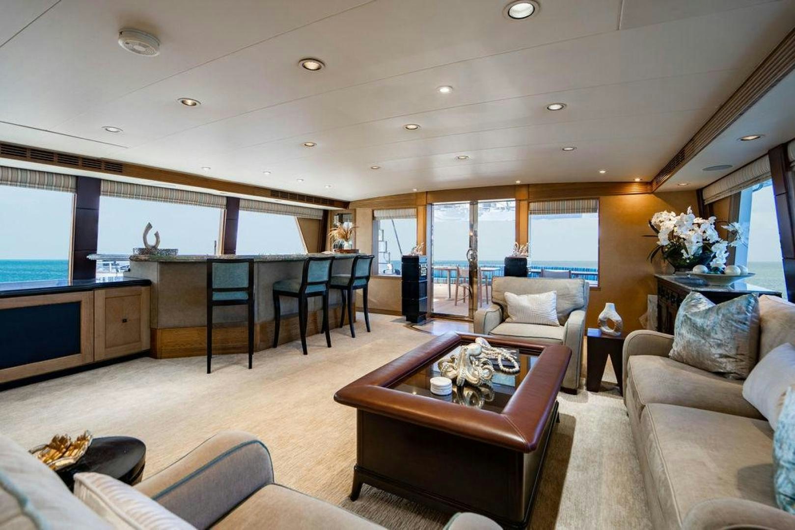 a living room with a table and chairs aboard NORTH COAST 120 Yacht for Sale