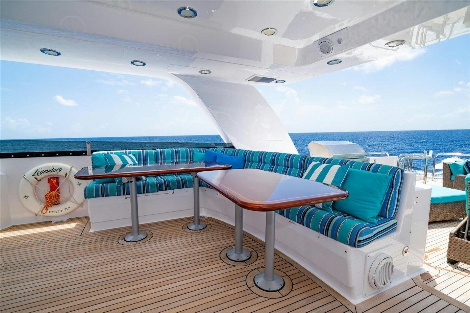 a room with a table and a couch aboard NORTH COAST 120 Yacht for Sale