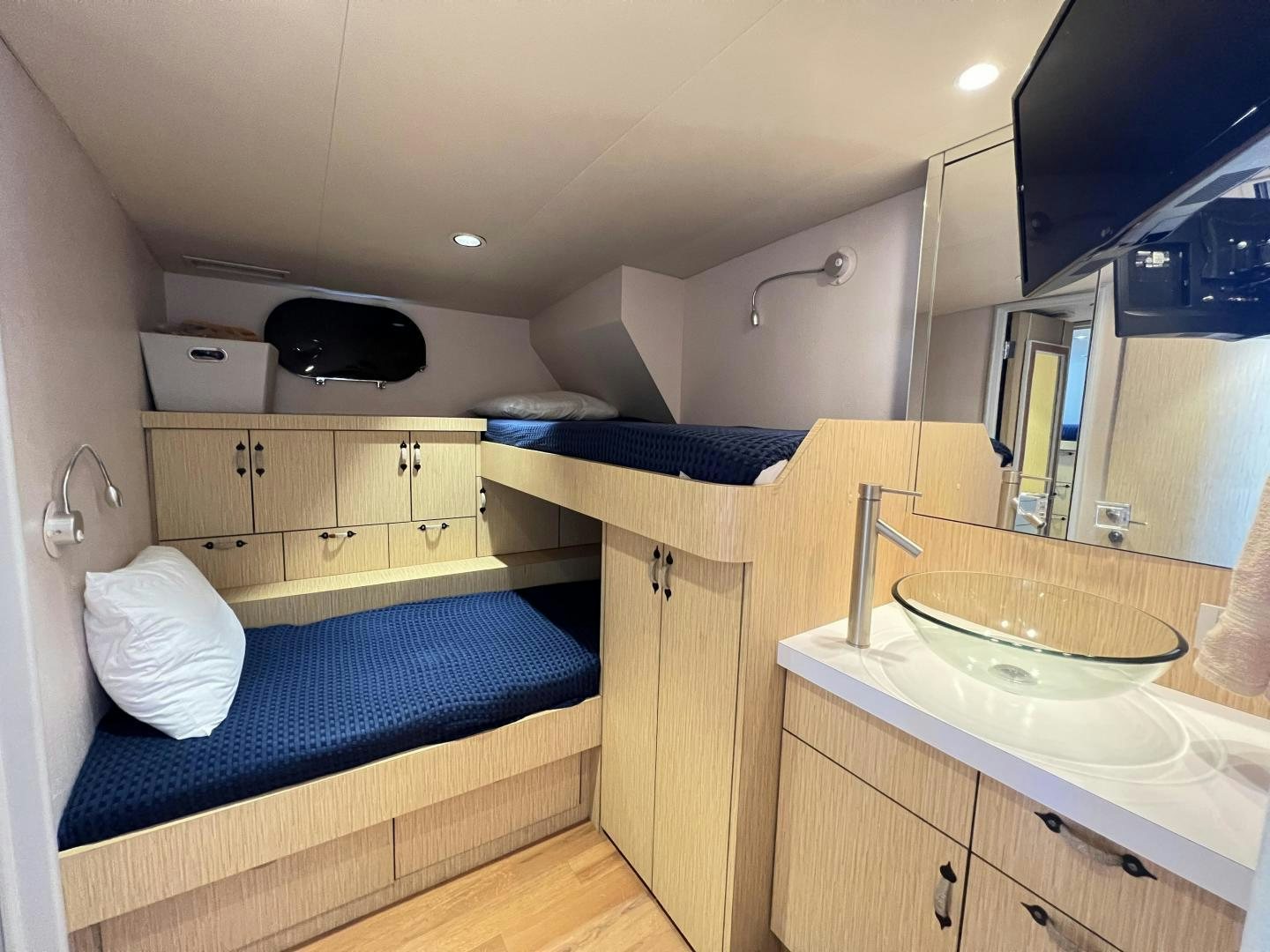 a small bathroom with a bed aboard NORTH COAST 120 Yacht for Sale