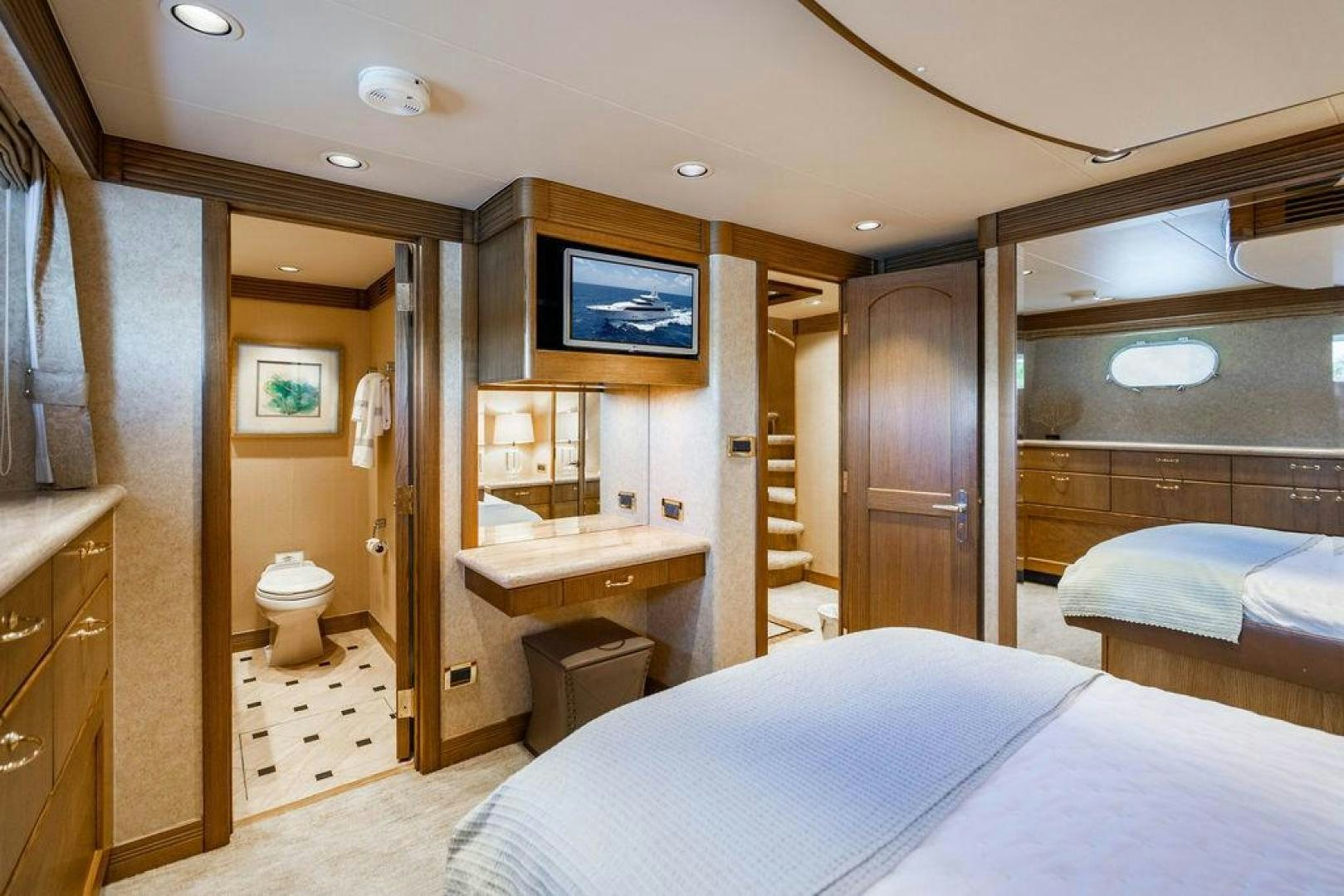 a bedroom with a bed and a television aboard NORTH COAST 120 Yacht for Sale