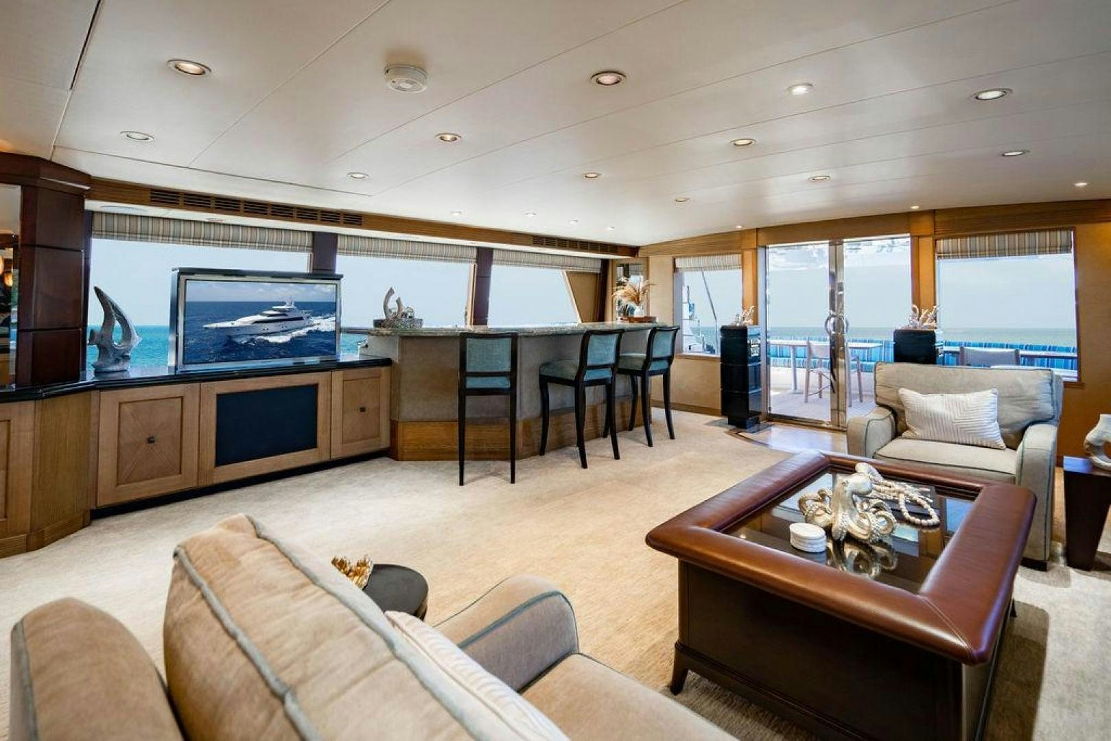 a living room with a large open kitchen and dining area aboard NORTH COAST 120 Yacht for Sale
