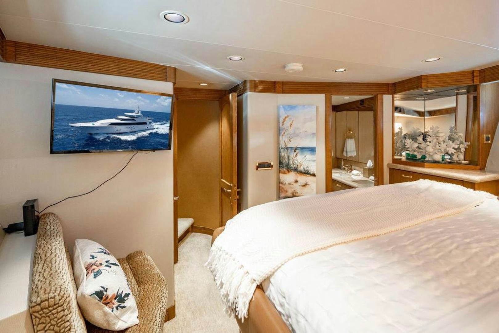 a bedroom with a bed and a television aboard NORTH COAST 120 Yacht for Sale