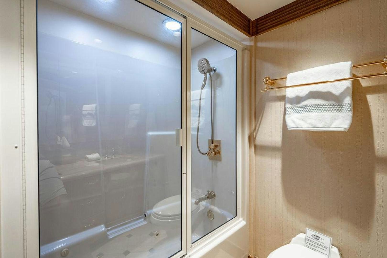 a bathroom with a glass shower aboard NORTH COAST 120 Yacht for Sale