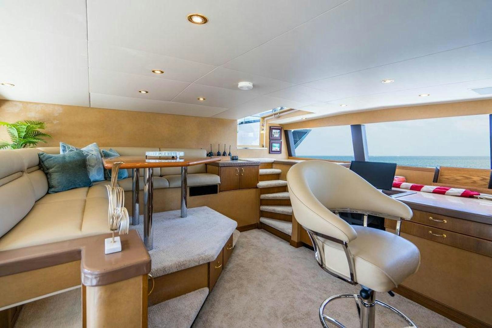a living room with a couch and a table aboard NORTH COAST 120 Yacht for Sale