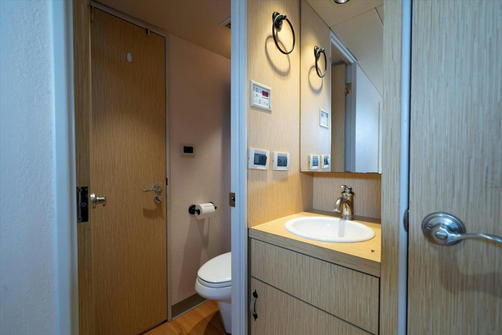 a bathroom with a sink and toilet aboard NORTH COAST 120 Yacht for Sale