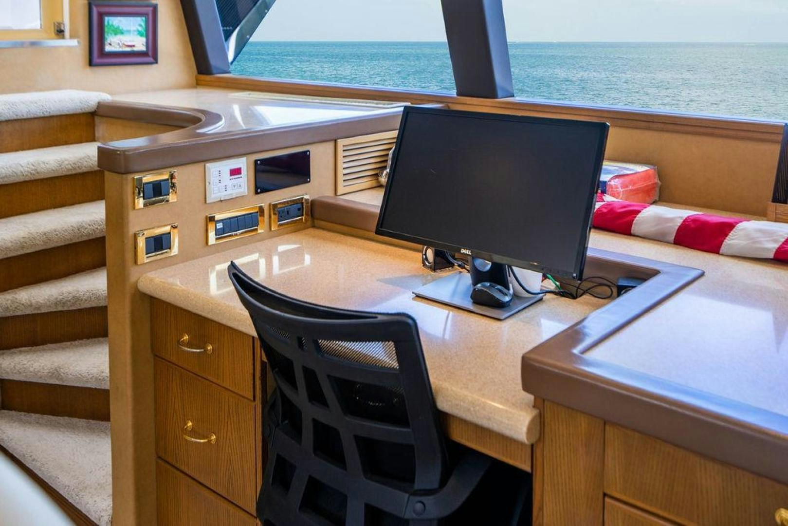 a desk with a computer on it aboard NORTH COAST 120 Yacht for Sale