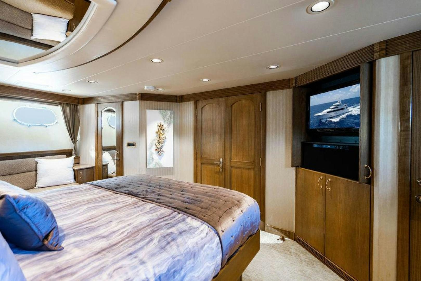 a bedroom with a bed and tv aboard NORTH COAST 120 Yacht for Sale
