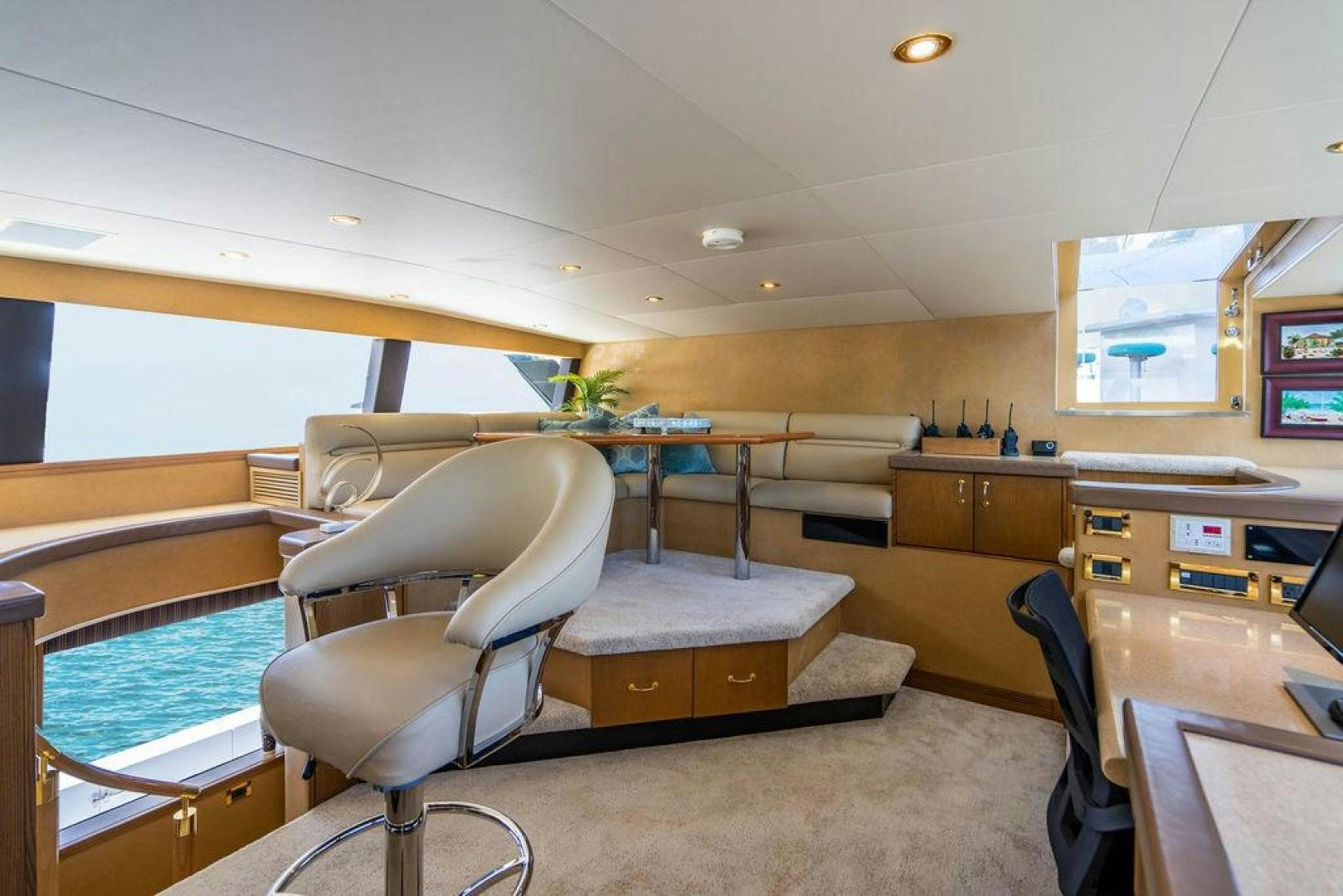a room with chairs and tables aboard NORTH COAST 120 Yacht for Sale