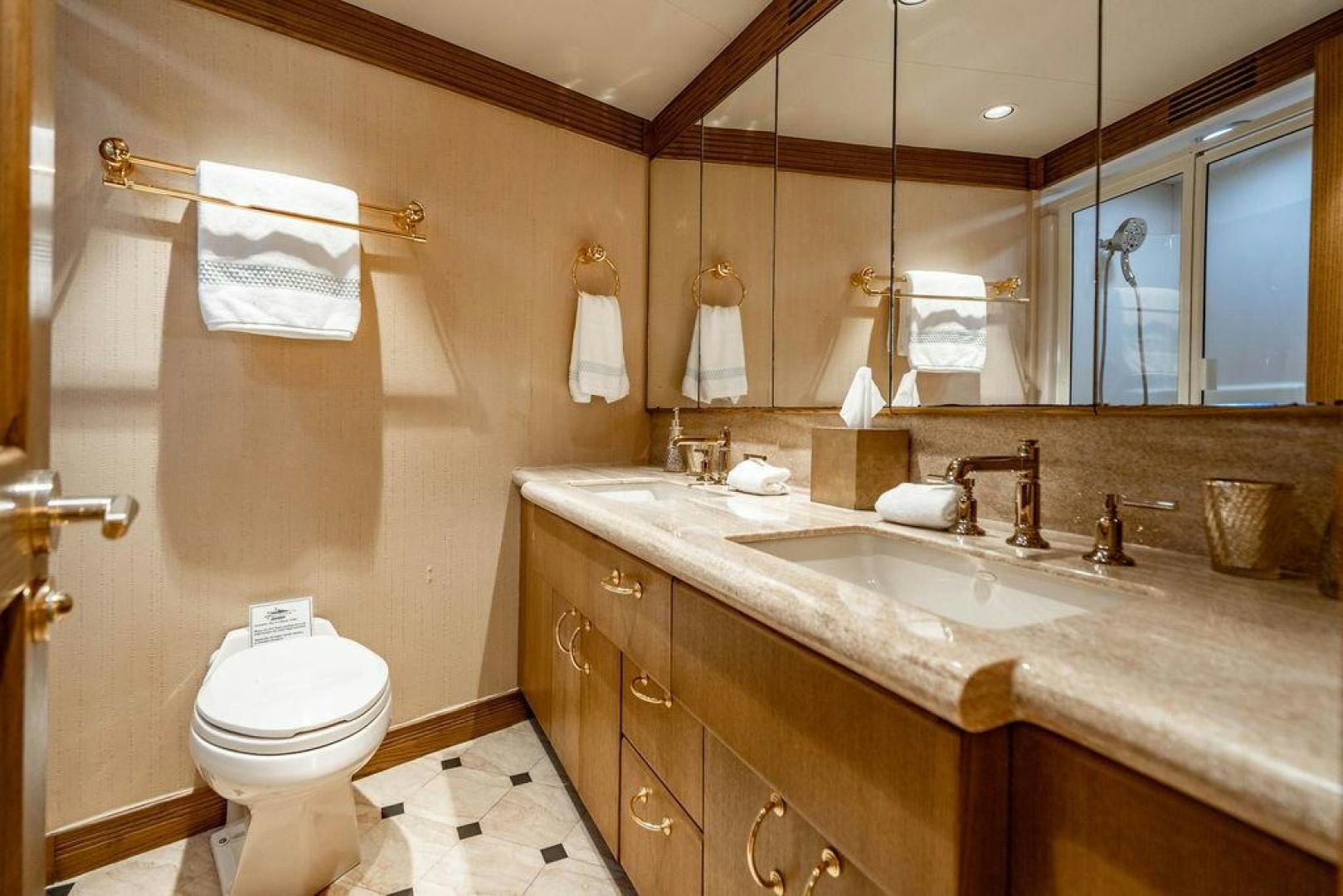 a bathroom with a sink toilet and a mirror aboard NORTH COAST 120 Yacht for Sale