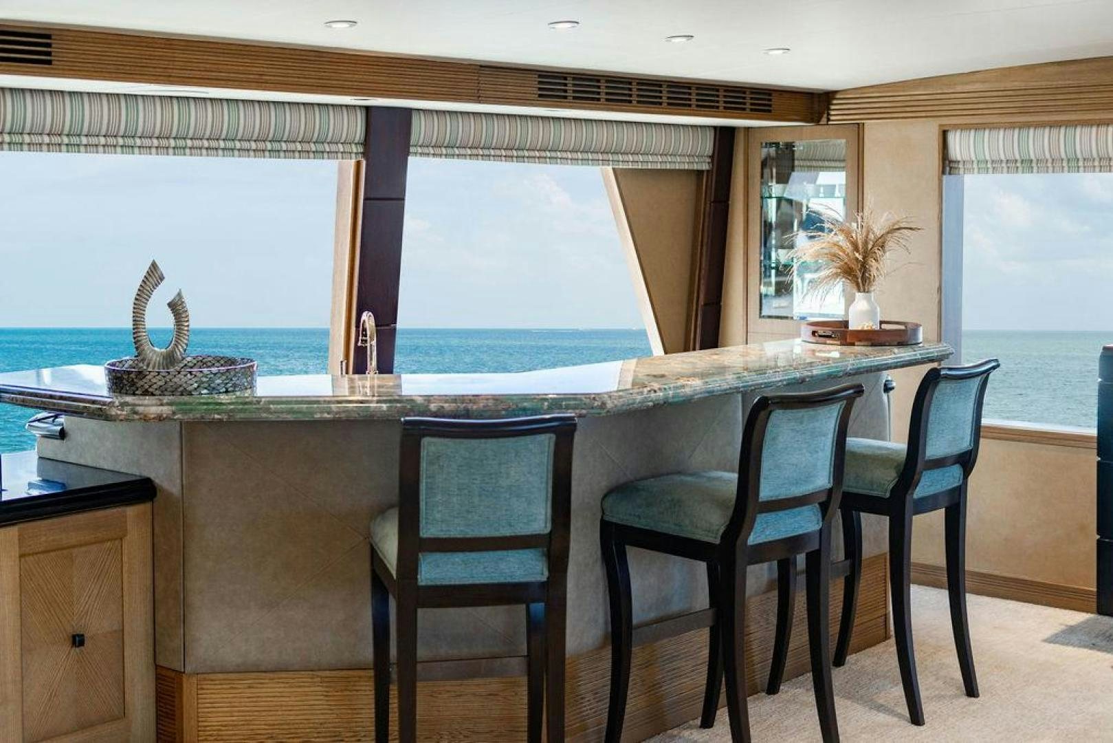 a kitchen with a table and chairs aboard NORTH COAST 120 Yacht for Sale