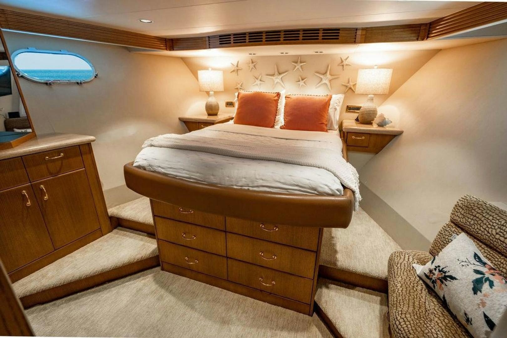 a bed with a wooden headboard aboard NORTH COAST 120 Yacht for Sale