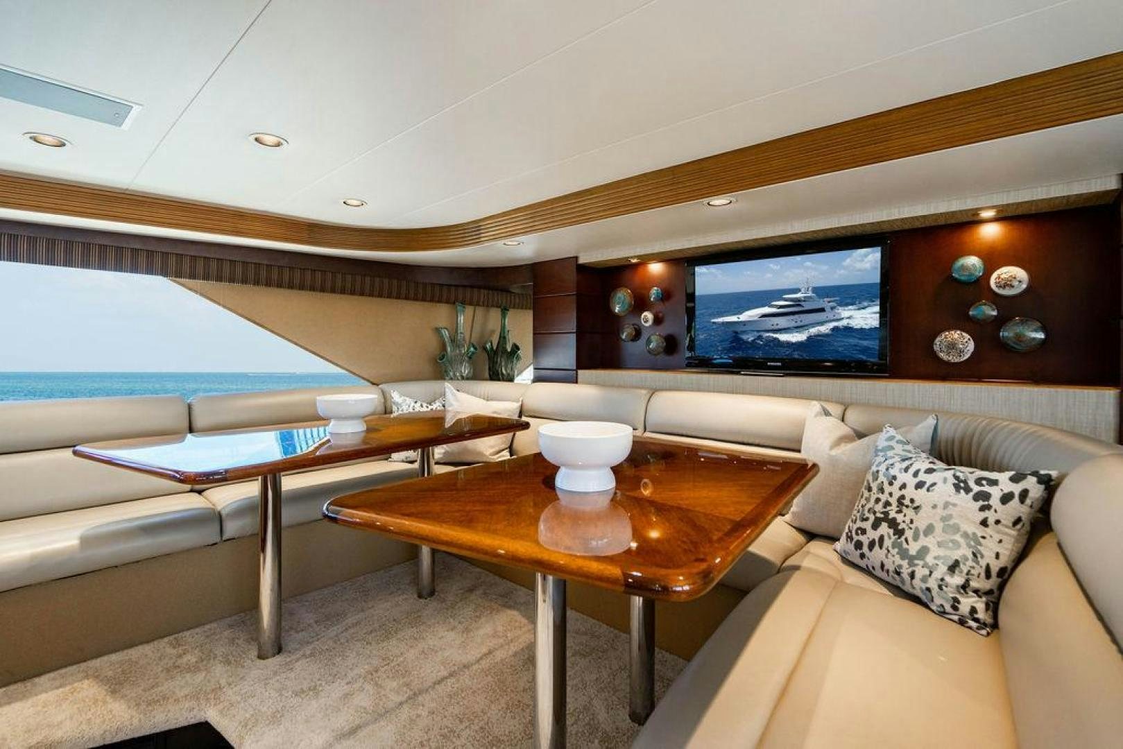a room with a table and couch aboard NORTH COAST 120 Yacht for Sale