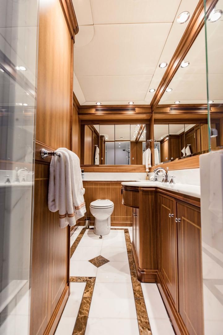 a bathroom with a toilet and sink aboard INVICTUS Yacht for Sale