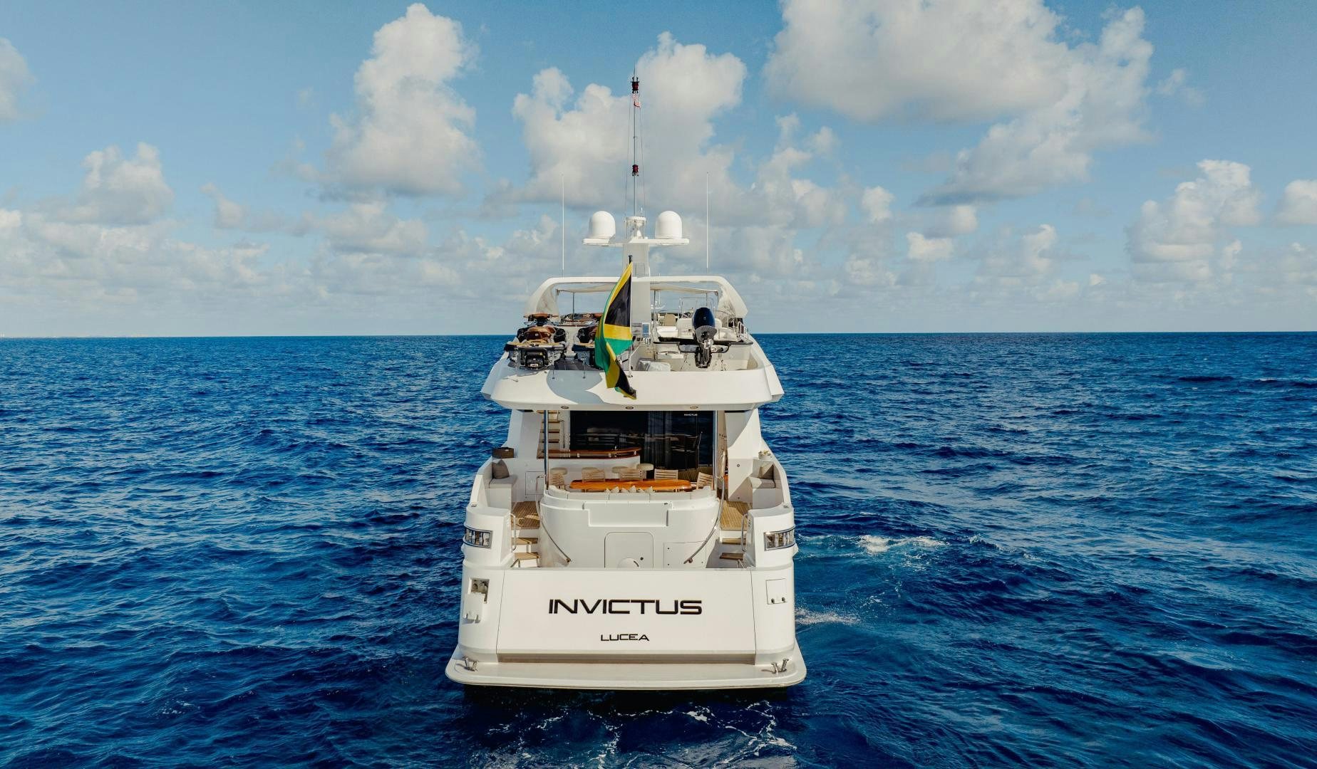 a white boat in the water aboard INVICTUS Yacht for Sale