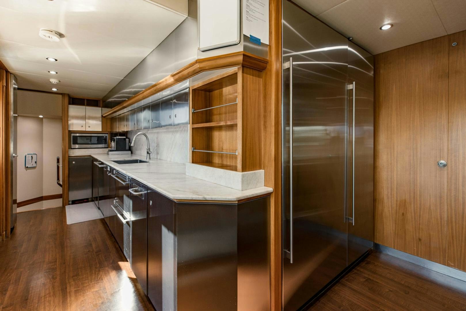 a kitchen with a glass door aboard INVICTUS Yacht for Sale
