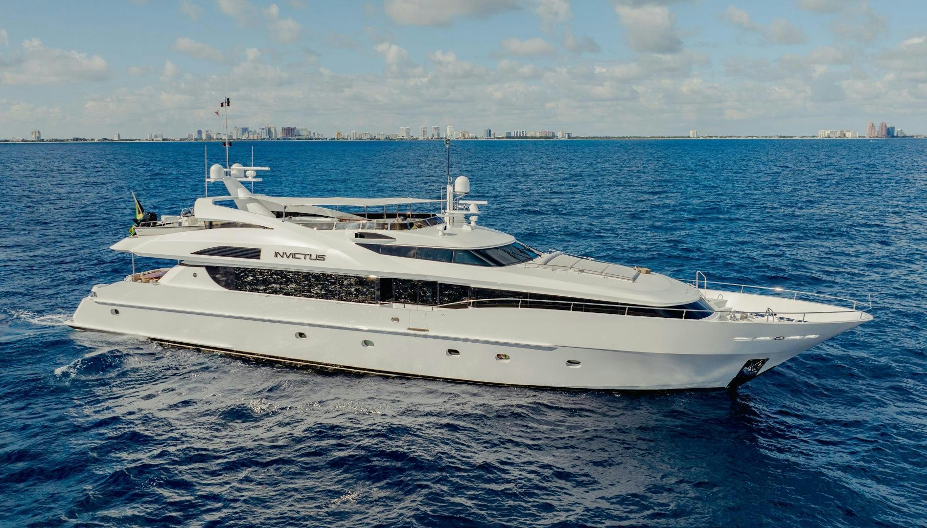 a white yacht in the water aboard INVICTUS Yacht for Sale