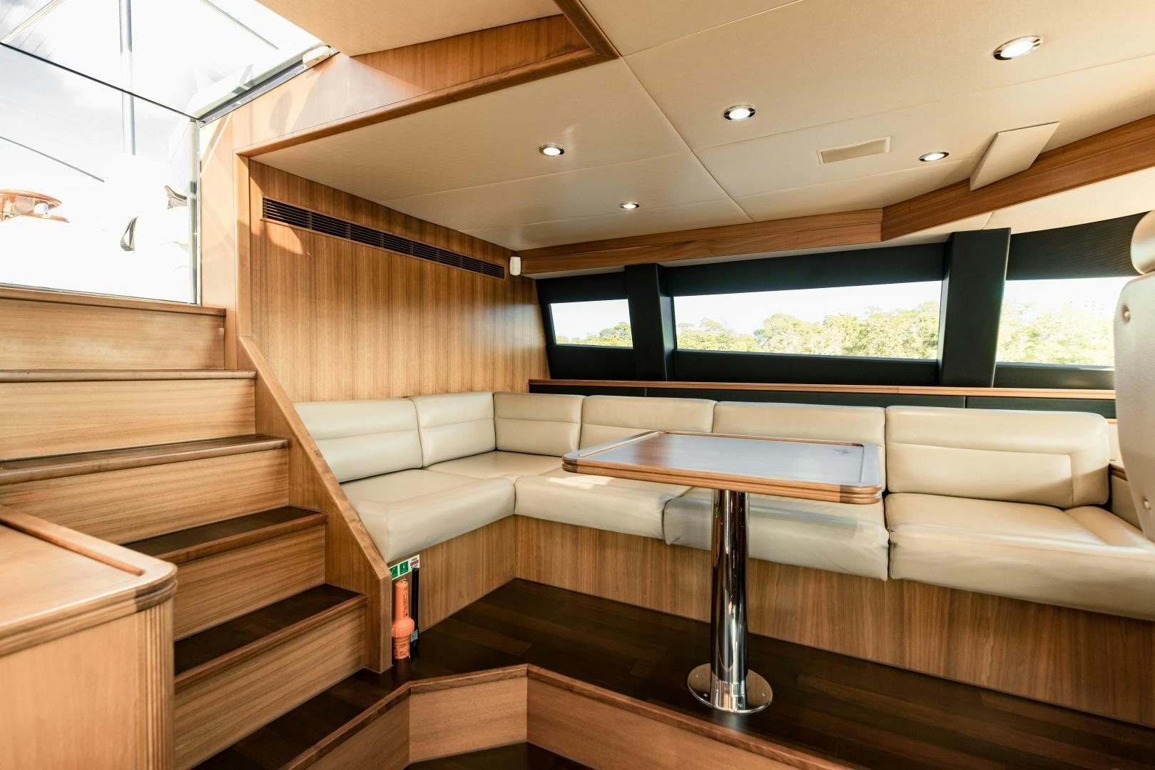 a room with a couch and a table aboard INVICTUS Yacht for Sale