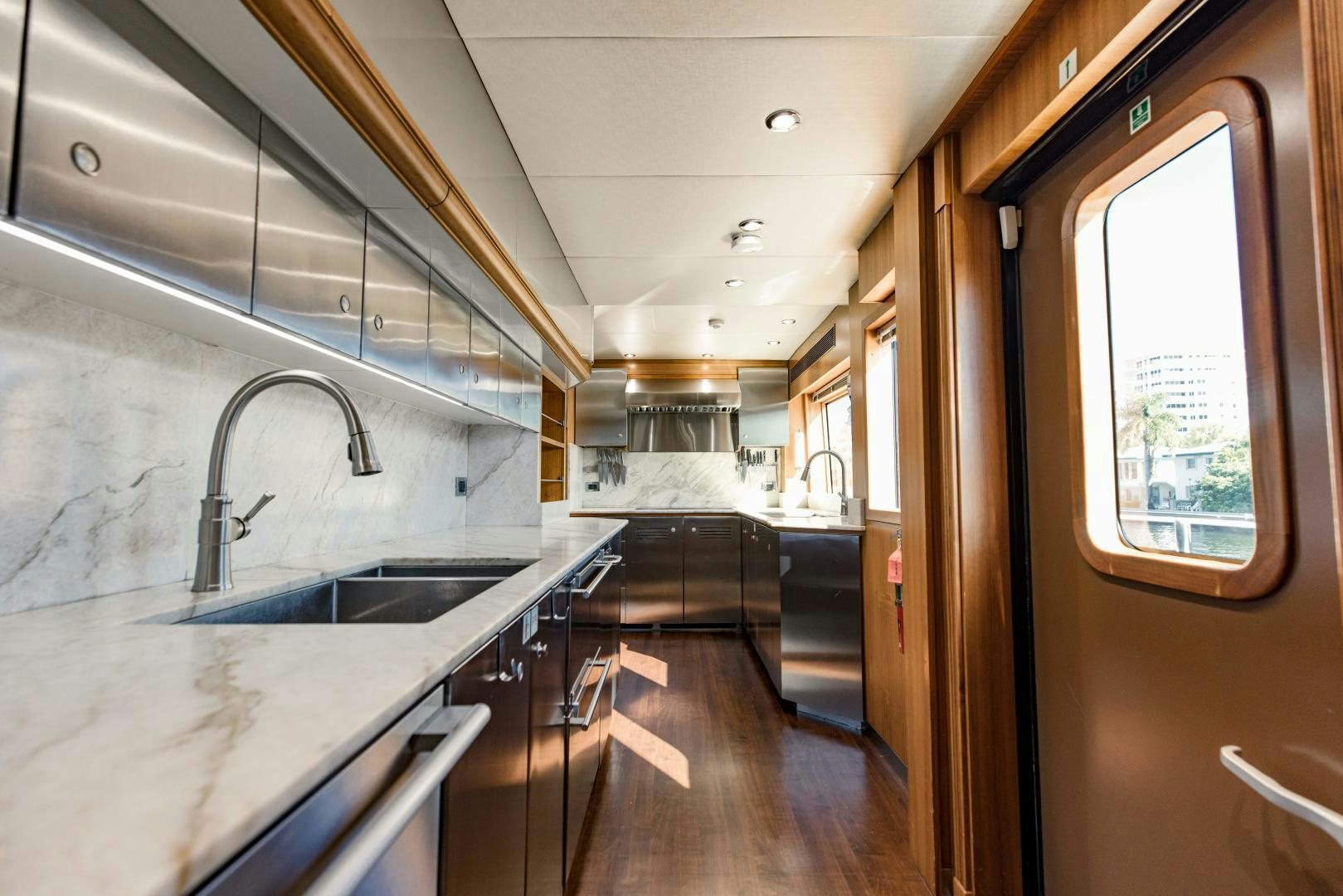 a kitchen with a sink and a large window aboard INVICTUS Yacht for Sale