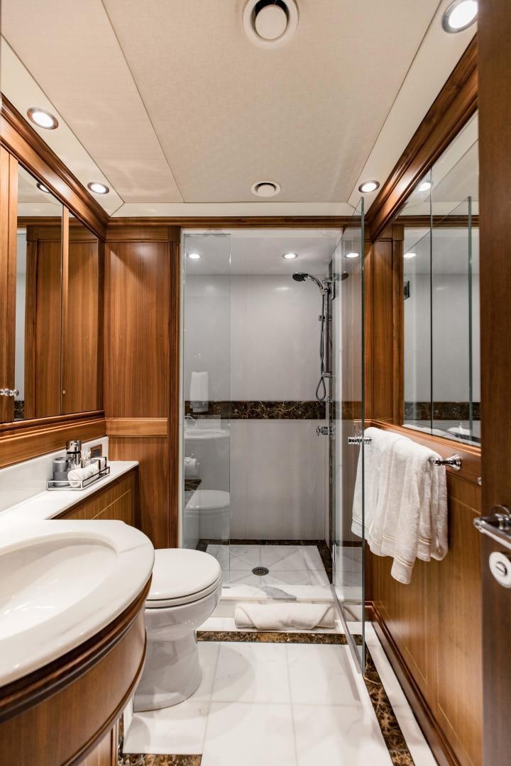 a bathroom with a glass shower aboard INVICTUS Yacht for Sale
